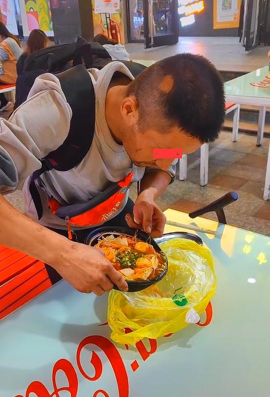 流浪男垃圾桶翻吃食,被好心人给米线却不吃,男子:老婆还没吃饭