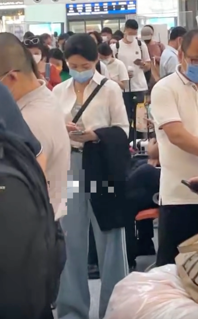 周涛|54岁周涛在高铁站低调排队！素颜出镜遮挡严实，低头玩手机太专注