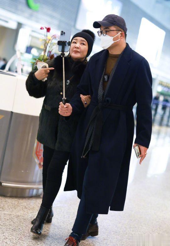 张兰|恋爱了?张兰与男子牵手现身机场,长相帅气身材高大,身份引猜测