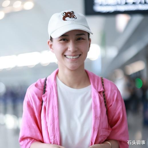 何超莲生子风波后现身机场,穿粉色套装素颜气色差,窦骁未陪同