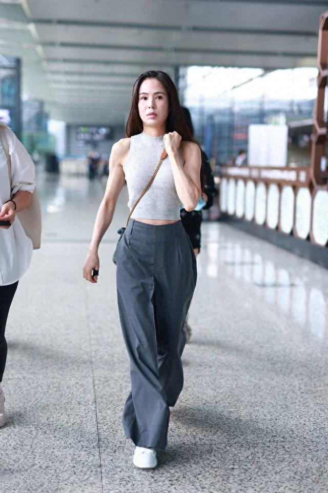 李若彤机场造型好大胆!素颜妆不化就出门,穿修身背心不像57岁人