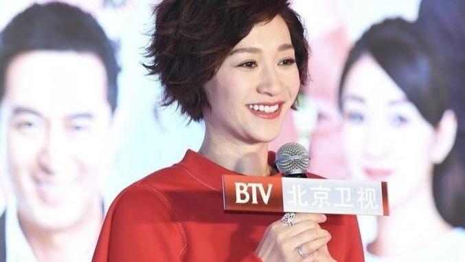 李小冉换了微卷短发减龄10岁，穿红卫衣+短裤+长筒靴，美出高度