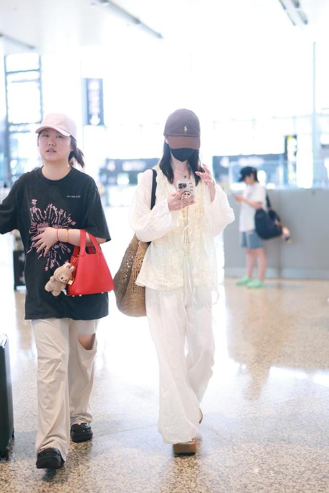 哈妮克孜现身上海机场,身穿白色look清新自然